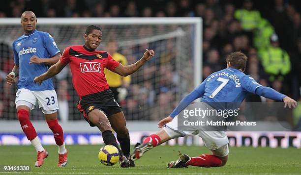 Antonio Valencia of Manchester United clashes with Hermann Hreidarsson of Portsmouth during the FA Barclays Premier League match between Portsmouth...