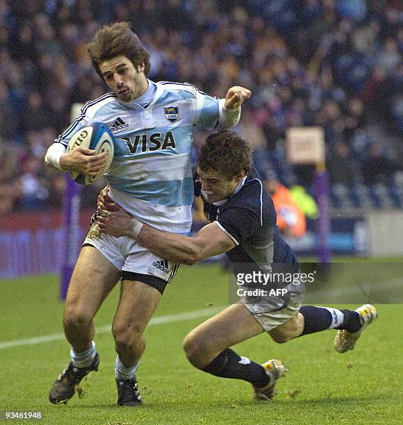 Argentina wing Lucas Borges is tackled by Scotland wing Thom Evans during the International rugby union match between Scotland and Argentina at...