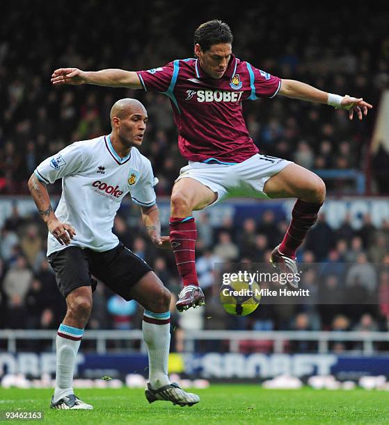 Guillermo Franco of West Ham is challenged by Clarke Carlisle of Burnley during the Barclays Premier League match between West Ham United and Burnley...