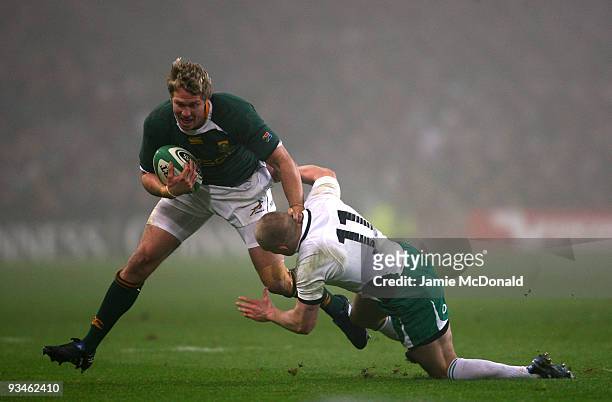 Jean De Villiers of South Africa is tackled by Keith Earles of Ireland during the Guinness Series 2009 match between Ireland and South Africa at...