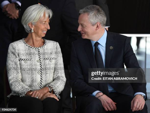 International Monetary Fund Managing Director Christine Lagarde and French Economy Minister Bruno Le Maire chat as they sit for the family picture of...