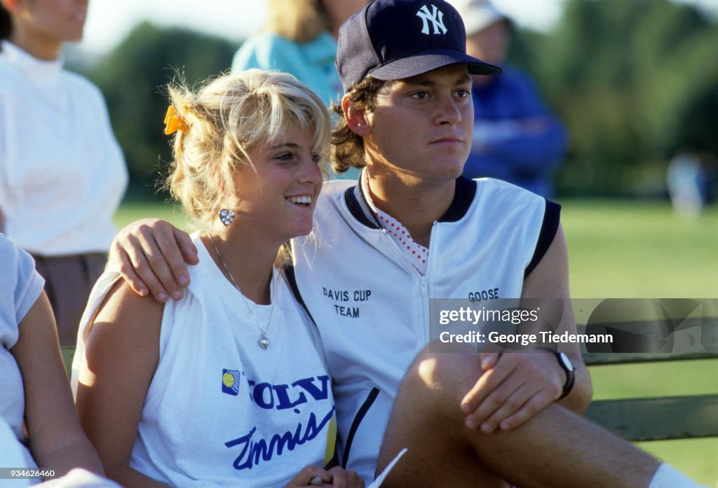Robert Seguso with fiance Carling Bassett watching softball game