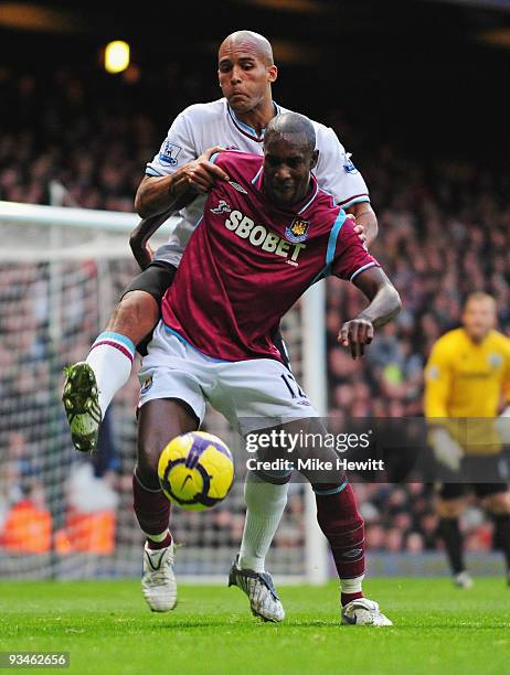 Carlton Cole of West Ham holds off Clarke Carlisle of Burnley during the Barclays Premier League match between West Ham United and Burnley at Upton...