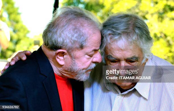 Brazilian former president Luiz Inacio Lula da Silva speaks with Uruguay's former president Jose Mujica during a meeting in Santana do Livramento,...