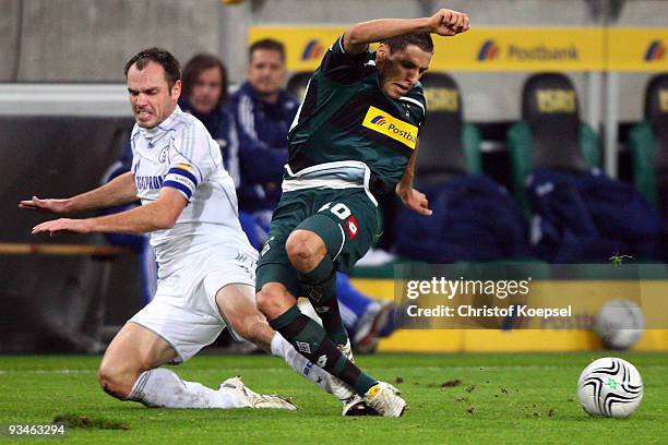 Heiko Westermann of Schalke tackles Karim Matmour of Moenchengladbach during the Bundesliga match between Borussia Moenchengladbach and FC Schalke 04...