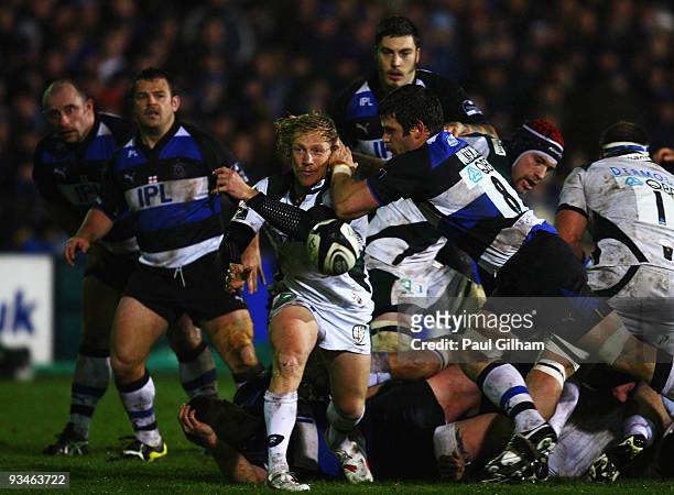 Paul Hodgson of London Irish is tackled by Luke Watson of Bath Rugby as he releases the ball during the Guinness Premiership match between Bath Rugby...