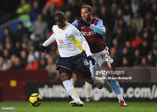John Carew of Aston Villa battles for the ball with Sebastien Bassong of Tottenham Hotspur during the Barclays Premier League match between Aston...