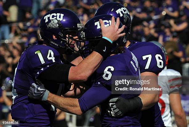 Quarterback Andy Dalton of the TCU Horned Frogs celebrates a touchdown with Bart Johnson against the New Mexico Lobos at Amon G. Carter Stadium on...