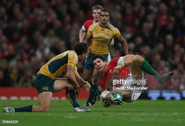James Hook of Wales is brought down by Quade Cooper of Australia during the Invesco Perpetual Series match between Wales and Australia at the...