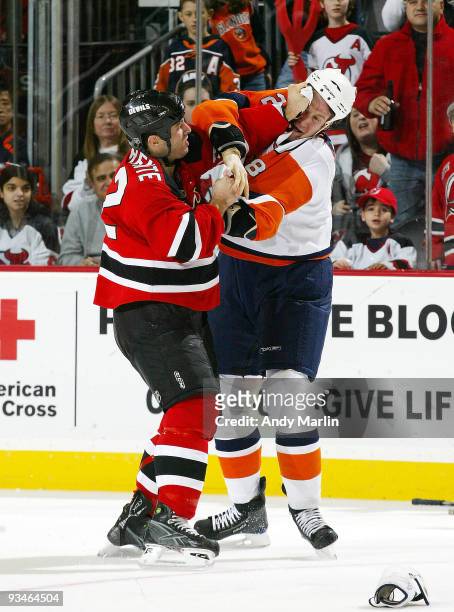 Tim Jackman of the New York Islanders and Matthew Corrente of the New Jersey Devils fight during their game at the Prudential Center on November 28,...