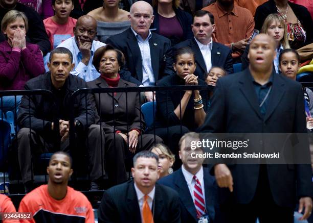 President Barack Obama watches along with his mother in law Marian Robinson wife first lady Michelle Obama daughter Sasha Obama , brother in law...