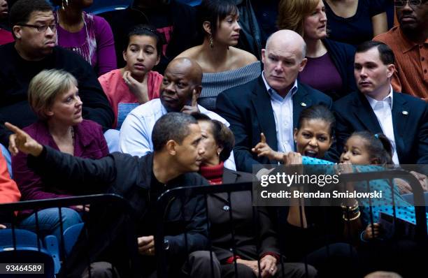 President Barack Obama watches with his mother in law Marian Robinson , First Lady Michelle Obama and daughter Sasha Obama during a college...