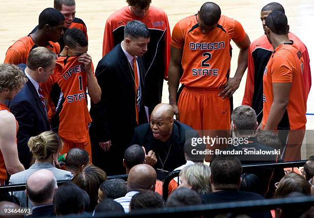 Craig Robinson coaches during a basketball game at George Washington University November 28, 2009 in Washington, DC. President Barack Obama attended...