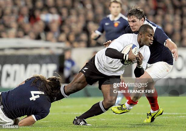 New Zealand's winger Sitiveni Sivivatu is tackled byFrance's lock Sebastien Chabal during the rugby union test match France vs. New Zealand, on...