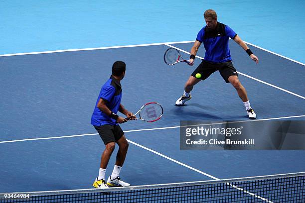 Mark Knowles of The Bahamas returns the ball playing with Mahesh Bhupathi of India during the men's doubles semi final match against Bob Bryan of USA...
