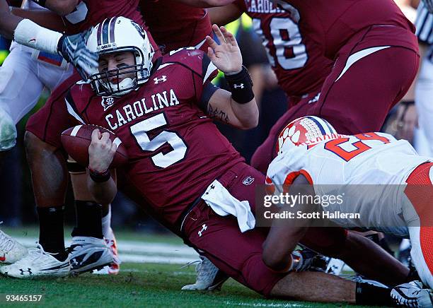 Stephen Garcia of the South Carolina Gamecocks is tackled by Kevin Alexander of the Clemson Tigers at Williams-Brice Stadium on November 28, 2009 in...