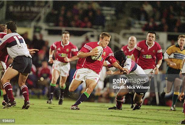 Jonny Wilkinson of the British Lions splits the defence during the Tour Match against Queensland Reds played at the Ballymore Stadium, in Brisbane,...