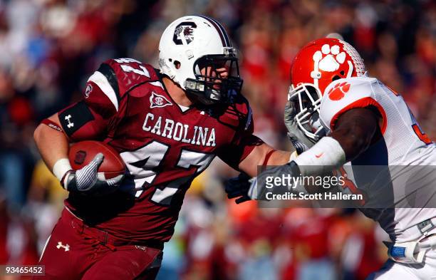 Patrick DiMarco of the South Carolina Gamecocks fights off the tackle of Kavell Conner of the Clemson Tigers at Williams-Brice Stadium on November...