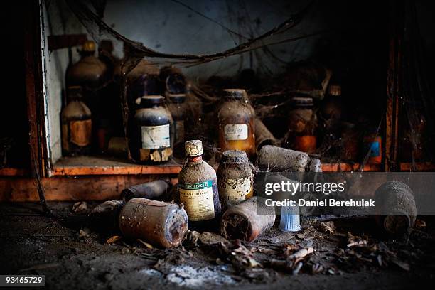 Discarded bottles of chemicals lay on the floor in a building at the site of the deserted Union Carbide factory on November 28, 2009 in Bhopal,...