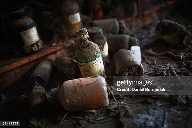 Discarded bottles of chemicals lay on the floor in a building at the site of the deserted Union Carbide factory on November 28, 2009 in Bhopal,...