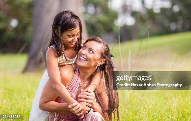 mother with her daughter enjoying outdoors. - nazar abbas stock pictures, royalty-free photos & images