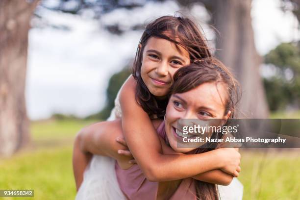 mother with her daughter enjoying outdoors. - maori family stock-fotos und bilder