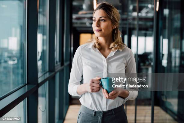 thoughtful businesswoman looking away - office drinks stock pictures, royalty-free photos & images