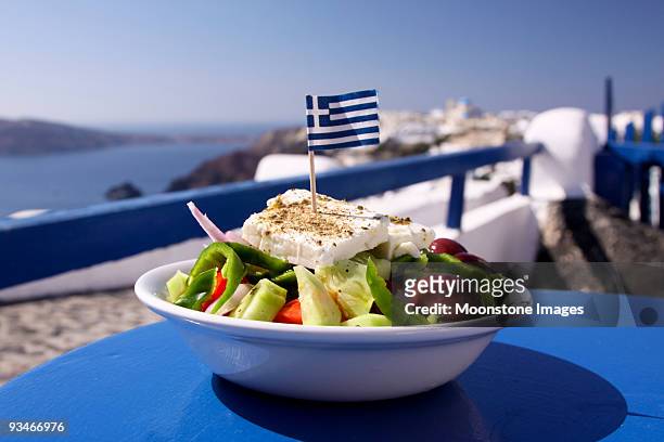 greek salad served by the water in santorini, greece - greece stock pictures, royalty-free photos & images