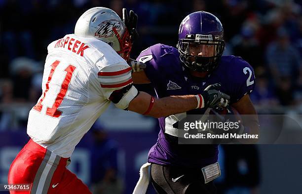 Tailback Joseph Turner of the TCU Horned Frogs runs the ball past Clint McPeek of the New Mexico Lobos at Amon G. Carter Stadium on November 28, 2009...