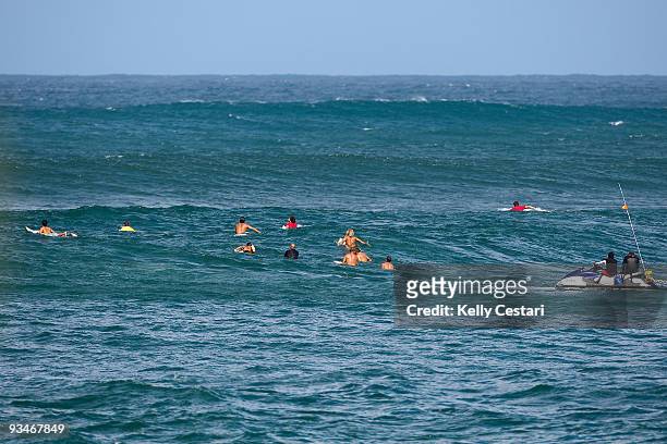 Surfboard caddies and contestants wait in the Sunset channel for a set of waves to arrive during Round 1 of the O'Neill World Cup of Surfing on...