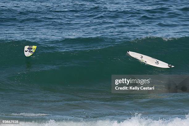 The broken surfboard of Dane Gudauskas of Australia floats back to the beach after being snapped while riding a wave during the O'Neill World Cup of...