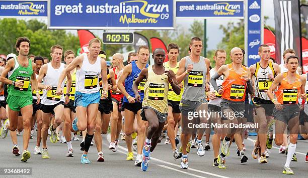 Olympic marathon champion Sammy Wanjiru of Kenya and Collis Birmingham of Australia lead the Elite male athletes race away from the starting line...