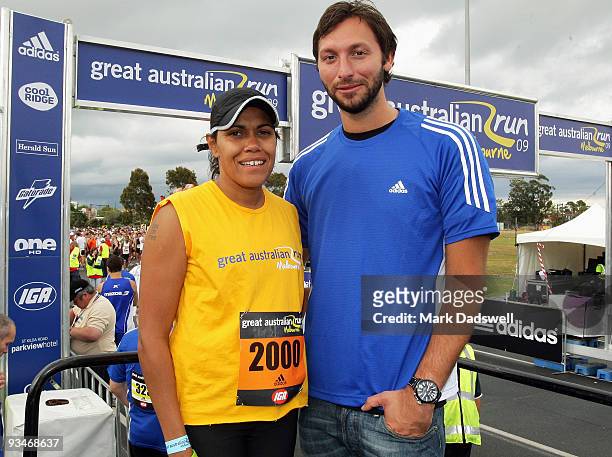 Competitor Cathy Freeman and official starter Ian Thorpe p pose together before the start of the race during the Australian Road Running...
