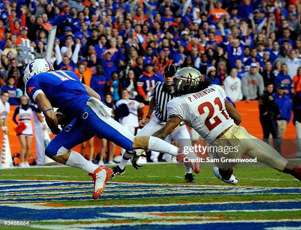 Riley Cooper of the Florida Gators catches a pass for a touchdown against Patrick Robinson of the Florida State Seminoles at Ben Hill Griffin Stadium...