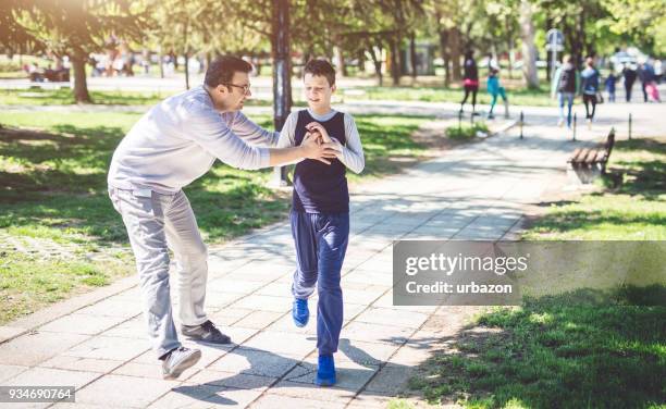 father with autistic son - autism awareness stock pictures, royalty-free photos & images