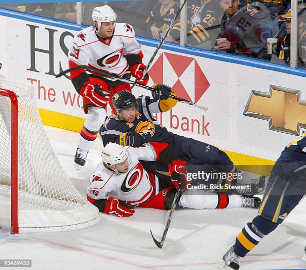 Derek Roy of the Buffalo Sabres falls on Brandon Sutter of the Carolina Hurricanes at HSBC Arena on November 28, 2009 in Buffalo, New York.