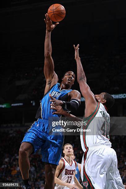 Dwight Howard of the Orlando Magic shoots a hook shot against Kurt Thomas of the Milwaukee Bucks on November 28, 2009 at the Bradley Center in...