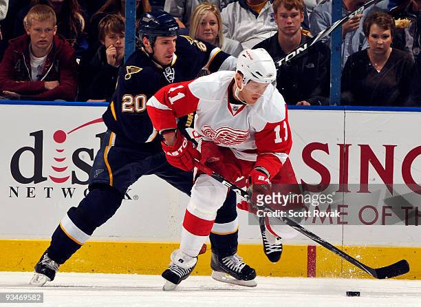 Daniel Cleary of the Detroit Red Wings battles Alexander Steen of the St. Louis Blues for the loose puck on November 28, 2009 at Scottrade Center in...