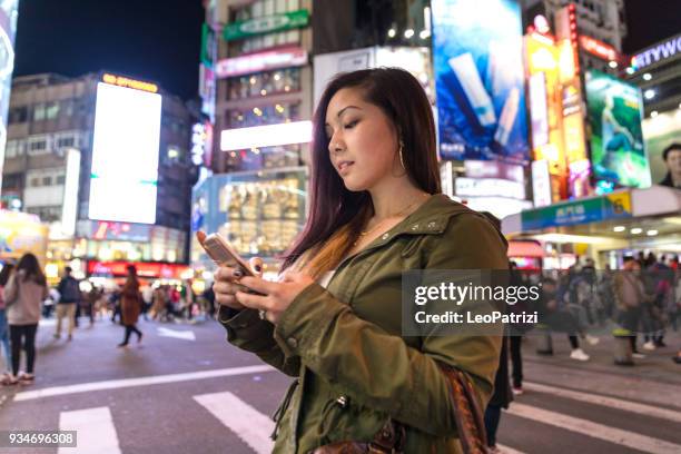 asian woman at night in ximen district downtown taipei - taiwan - ximen stock pictures, royalty-free photos & images