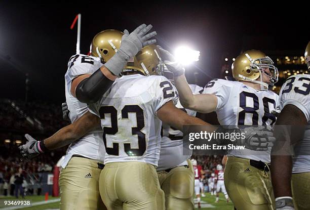 Golden Tate of the Notre Dame Fighting Irish is congratulated by teammates after he scored a touchdown during their game against the Stanford...