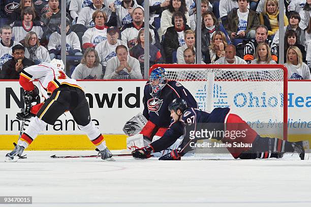 Rostislav Klesla of the Columbus Blue Jackets dives to block a shot from Jarome Iginla of the Calgary Flames during the third period on November 28,...