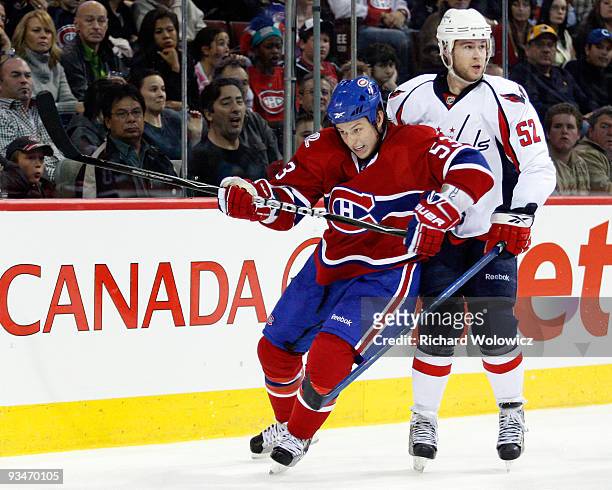 Ryan White of the Montreal Canadiens and Mike Green of the Washington Capitals collide during the NHL game on November 28, 2009 at the Bell Centre in...
