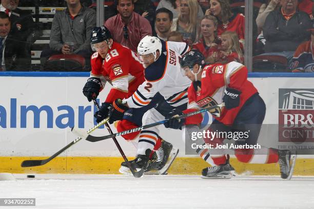 Andrej Sekera of the Edmonton Oilers defends against Jamie McGinn and Denis Malgin of the Florida Panthers during a Panther power play at the BB&T...