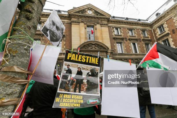 Signs againt Israel and Israeli Prime Minister Benjamin Netanyahu during a demonstration on March 19 in front of the court of Versailles, near Paris,...