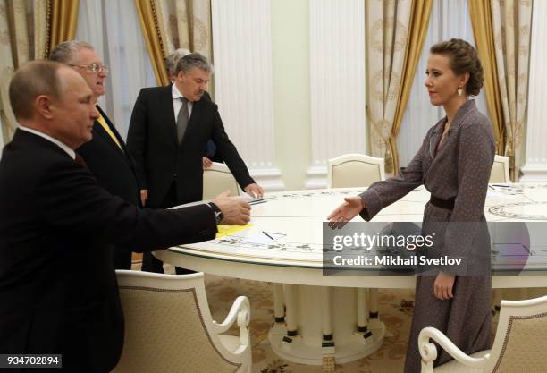 Russian President Vladimir Putin greets liberal opposition candidate Ksenia Sobchak as LDPR Party Leader Vladimir Zhirinovsky and Connunist Party...