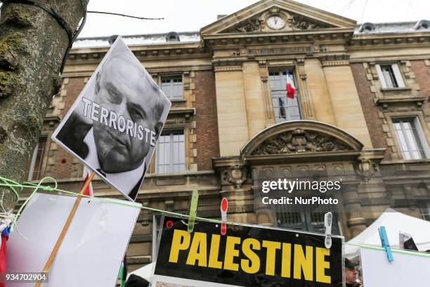 Signs againt Israel and Israeli Prime Minister Benjamin Netanyahu during a demonstration on March 19 in front of the court of Versailles, near Paris,...