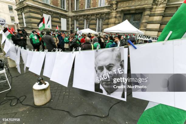 Signs againt Israeli Prime Minister Benjamin Netanyahu during a demonstration on March 19 in front of the court of Versailles, near Paris, in support...