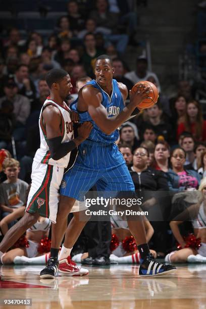 Dwight Howard of the Orlando Magic posts up against Hakim Warrick of the Milwaukee Bucks on November 28, 2009 at the Bradley Center in Milwaukee,...