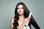 Attractive Woman with Curly Hair and Long Straight Hair Using Hair Straightener. Hair Problem and Haircare Concept