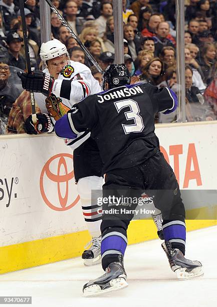 Marian Hossa of the Chicago Black Hawks takes a check from Jack Johnson of the Los Angeles Kings during the first period at the Staples Center on...